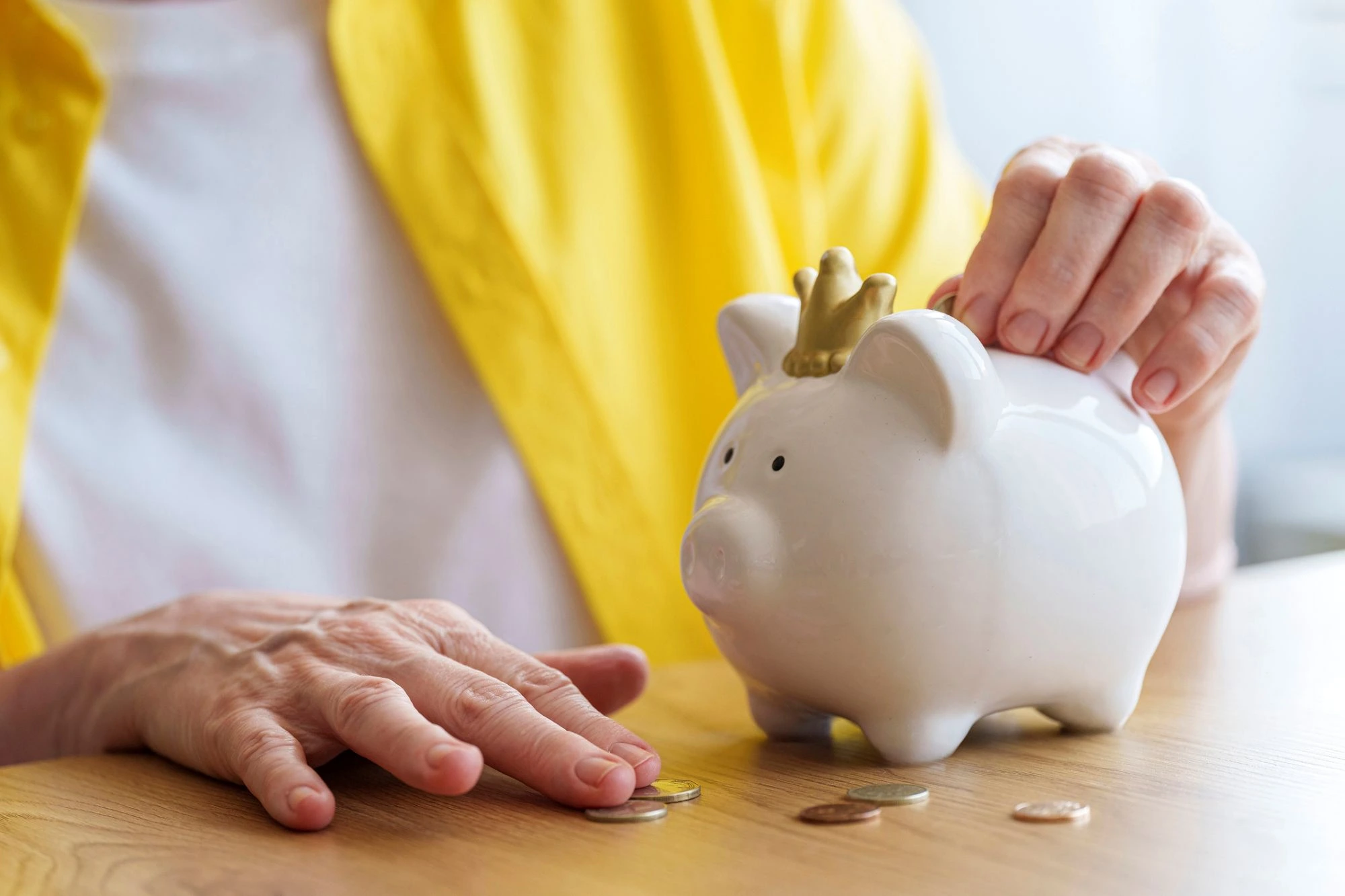 woman with piggy bank feeding coins