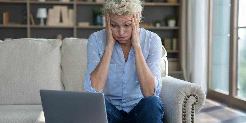 confused, frustrated older woman sitting in front of her computer