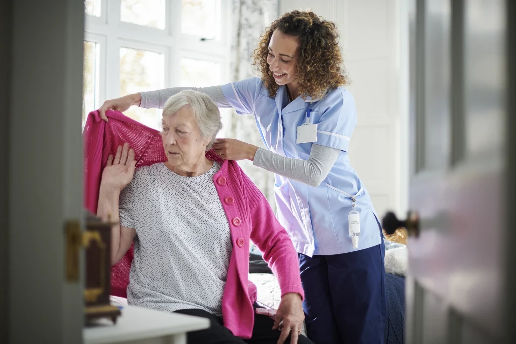 dementia care senior and caregiver getting dressed