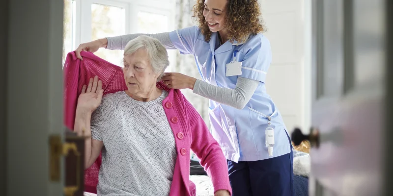 dementia care senior and caregiver getting dressed