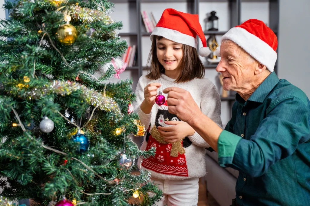 granddad and granddaughter hanging ornaments