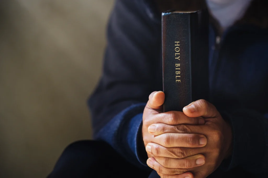 praying hands holy bible
