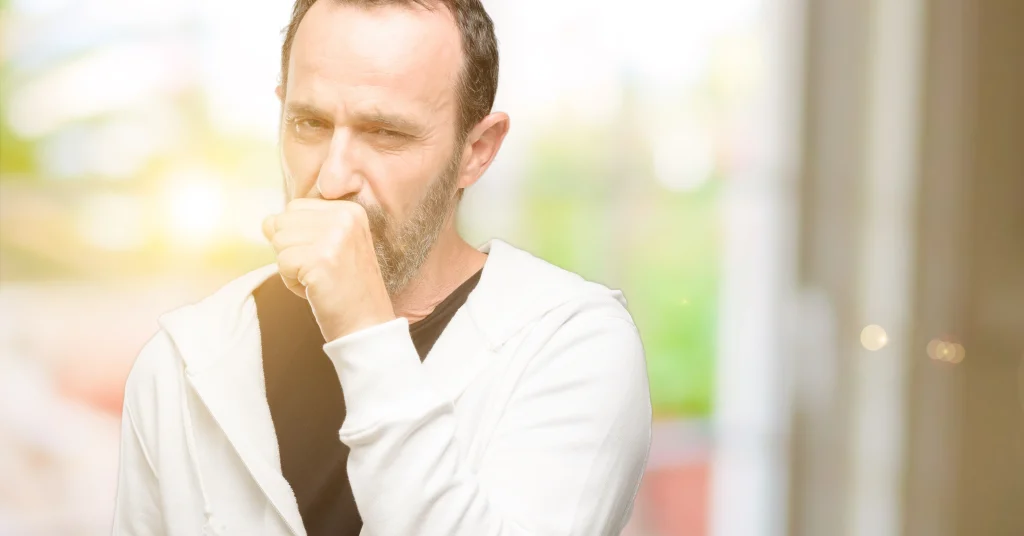 older man coughing