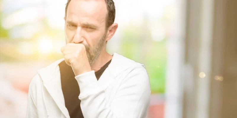 older man coughing