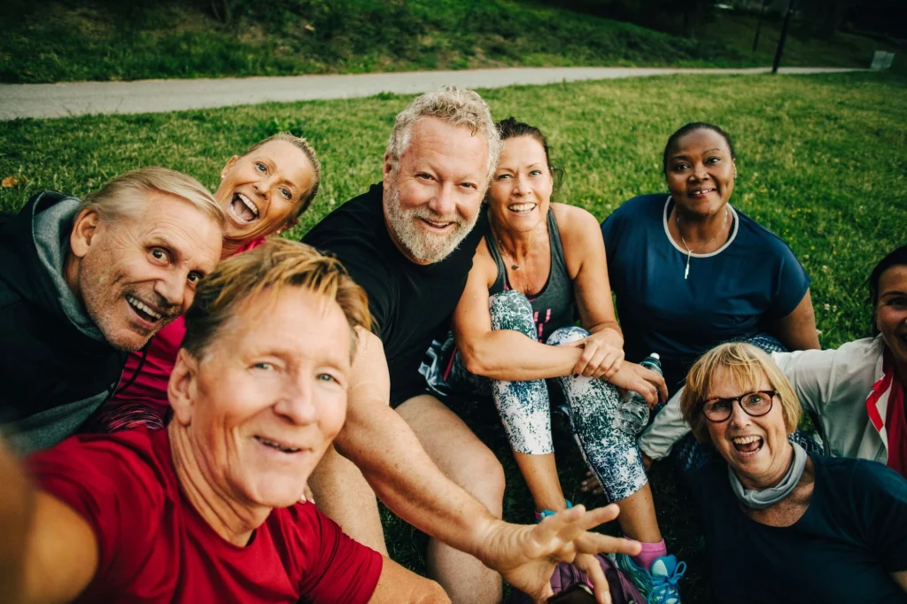 senior friends outside on grass