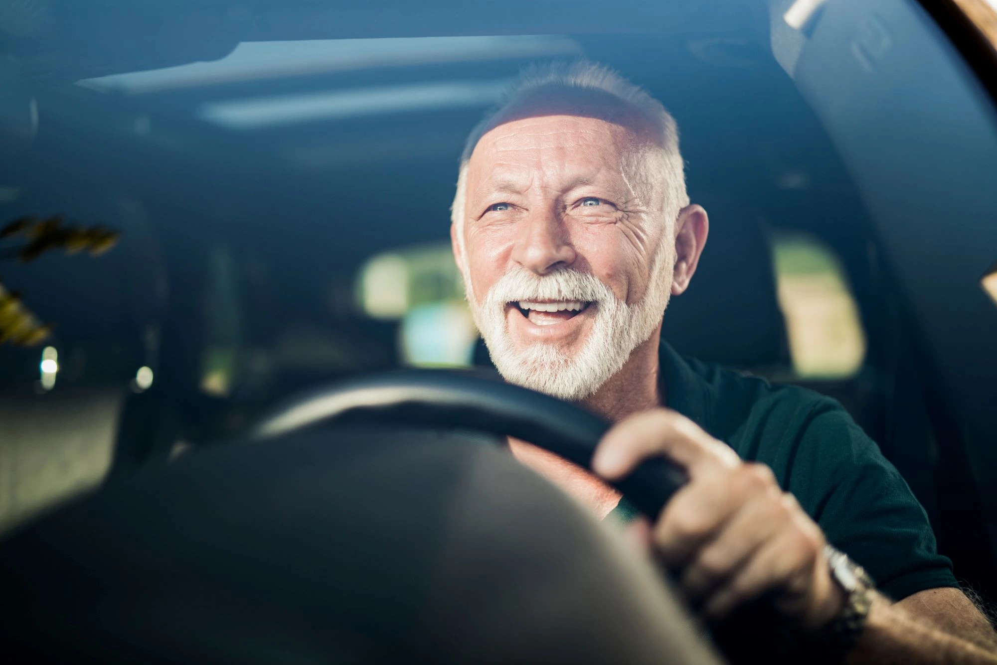 older man driving a car