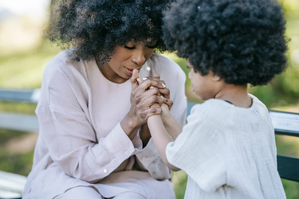 mom praying with daughter