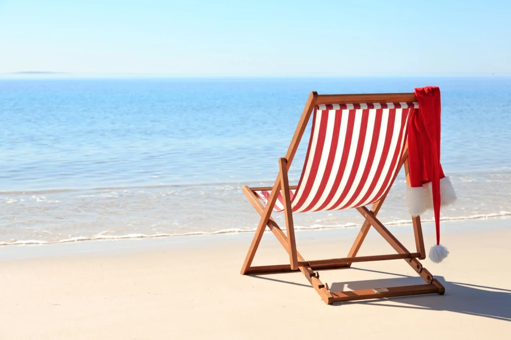 santa hat hanging on a striped beach chair