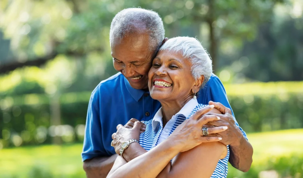 senior couple black hugging outside