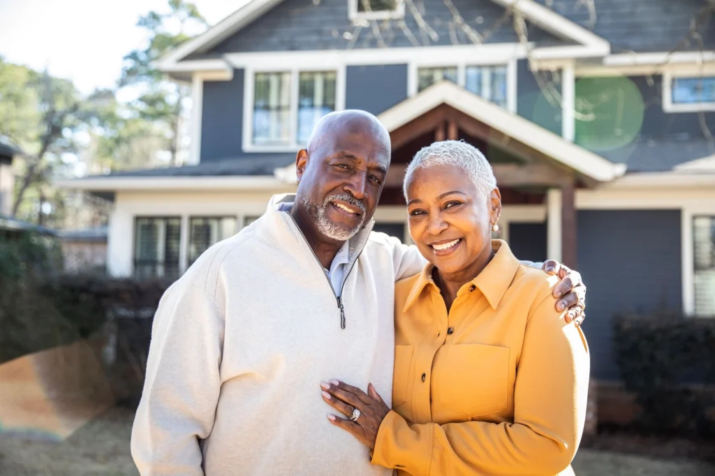 senior couple outside of their home
