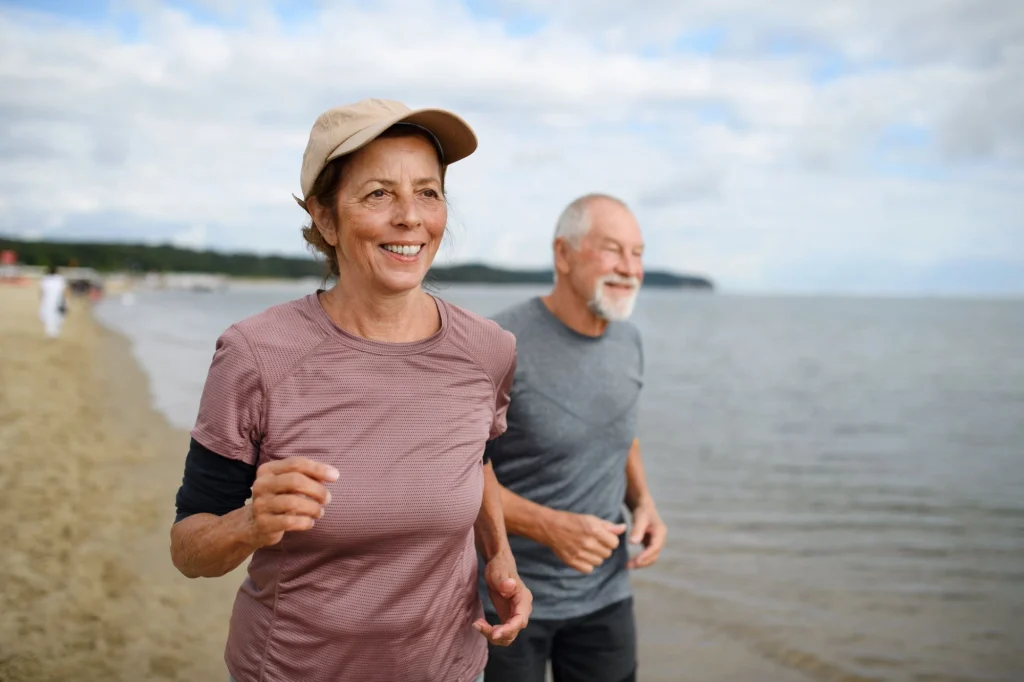 senior runners on the beach