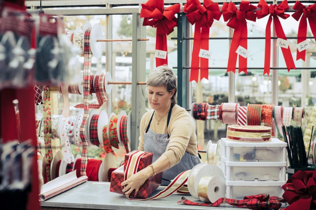 lady tying boxes in a christmas store