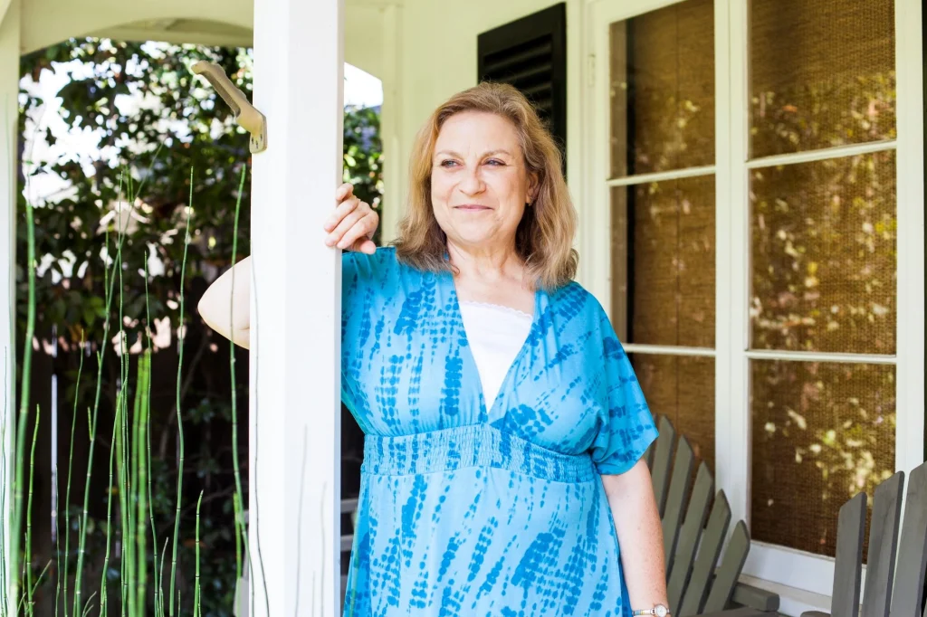 wom in blue dress on porch