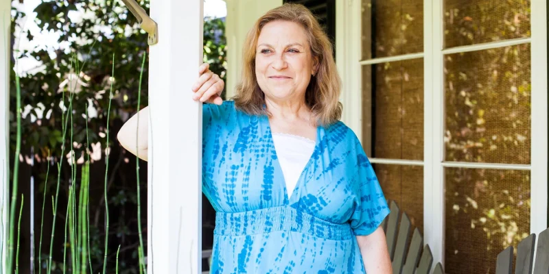wom in blue dress on porch