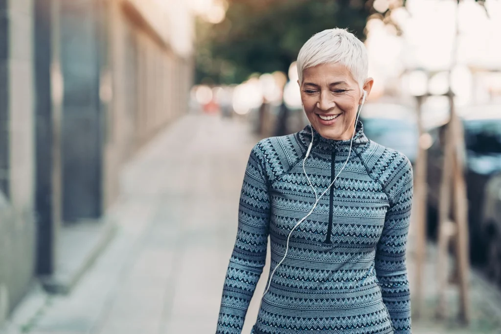 old lady walking with earbuds