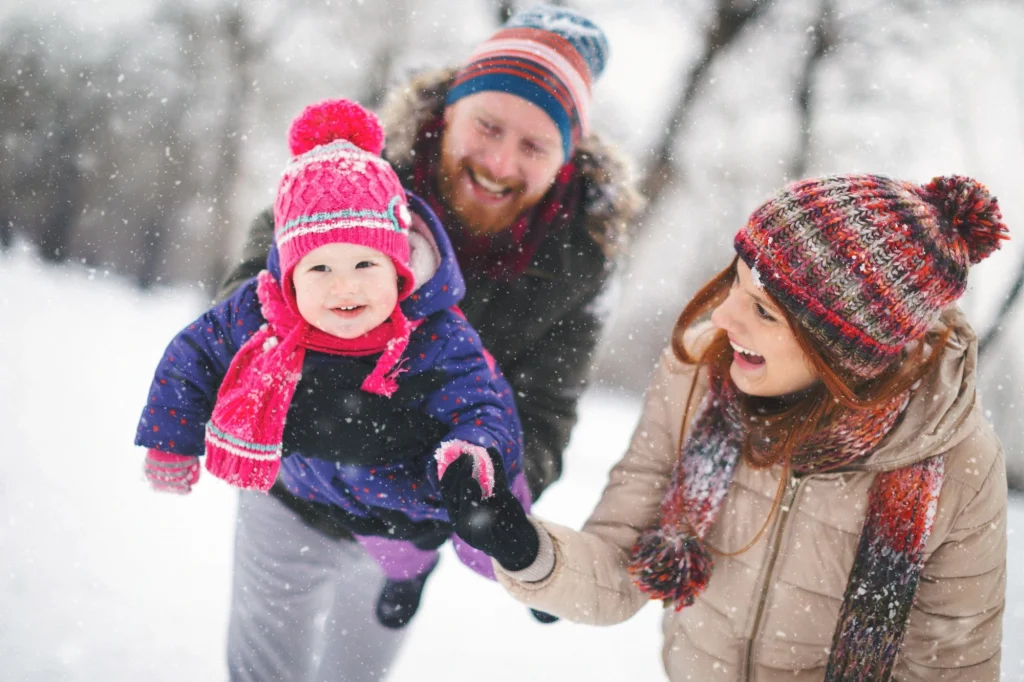 baby and parents outside in snow