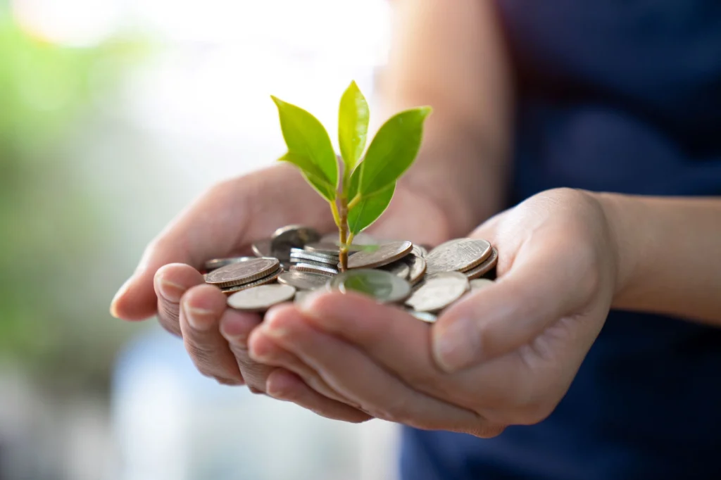 coins and tree in cupped palms