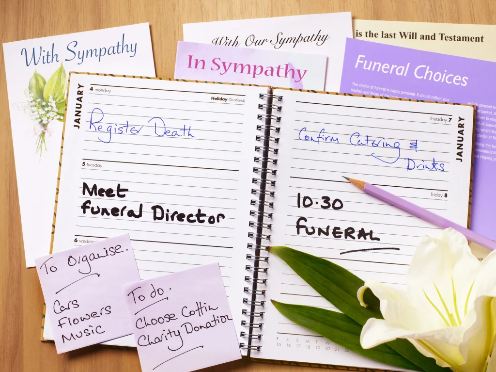 funeral plans in an open planner with flower and sticky notes