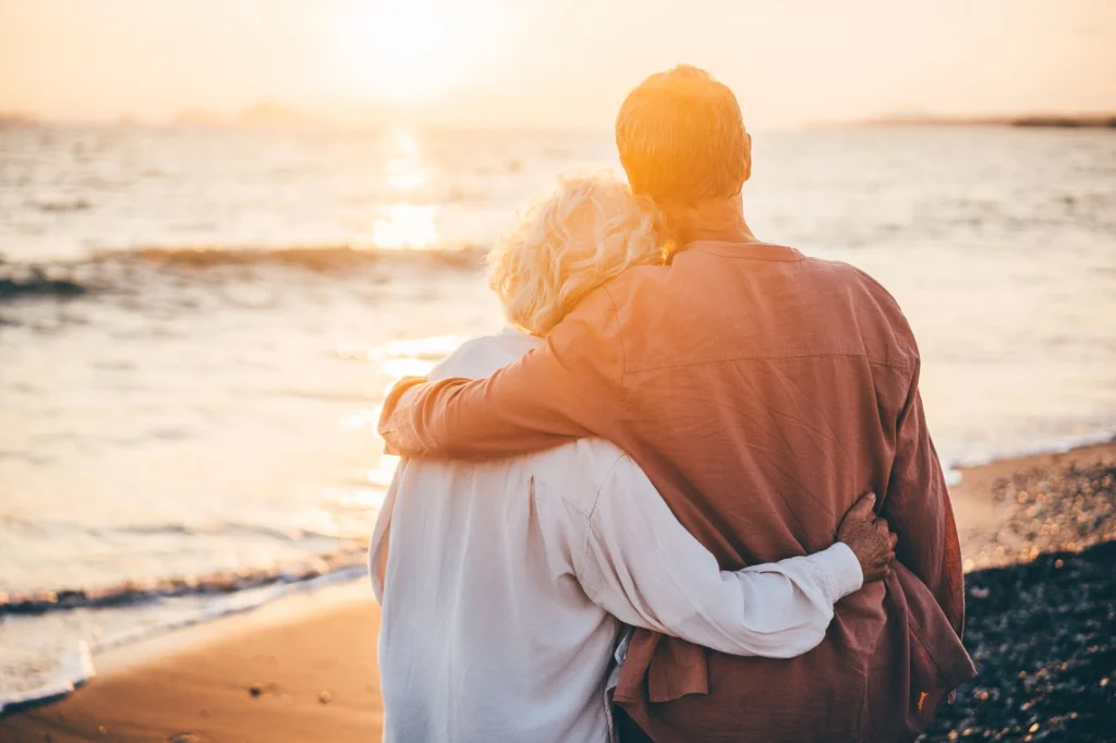 glowy sunset mature couple enjoying time on the beach