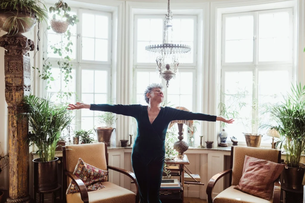 senior lady in apartment holding her hands to the side