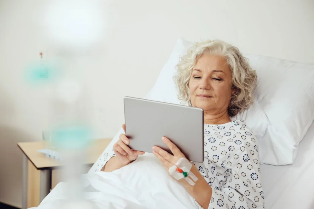 lying in bed holding an ipad