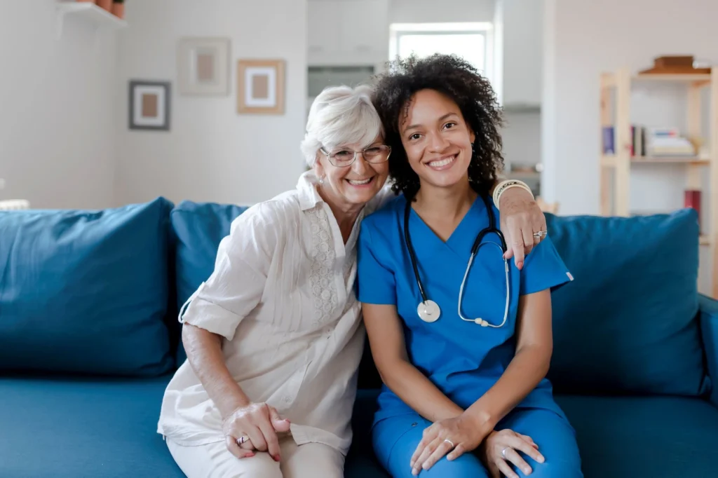 nurse and lady sitting on couch