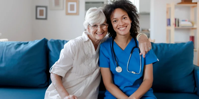 senior woman and a nurse in an assisted living setting