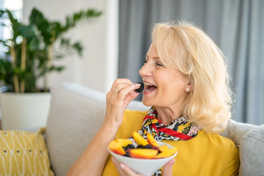 eating berries older lady on the couch