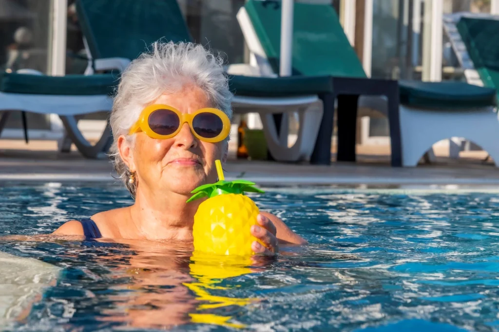lady with sunglasses and pineapple cup