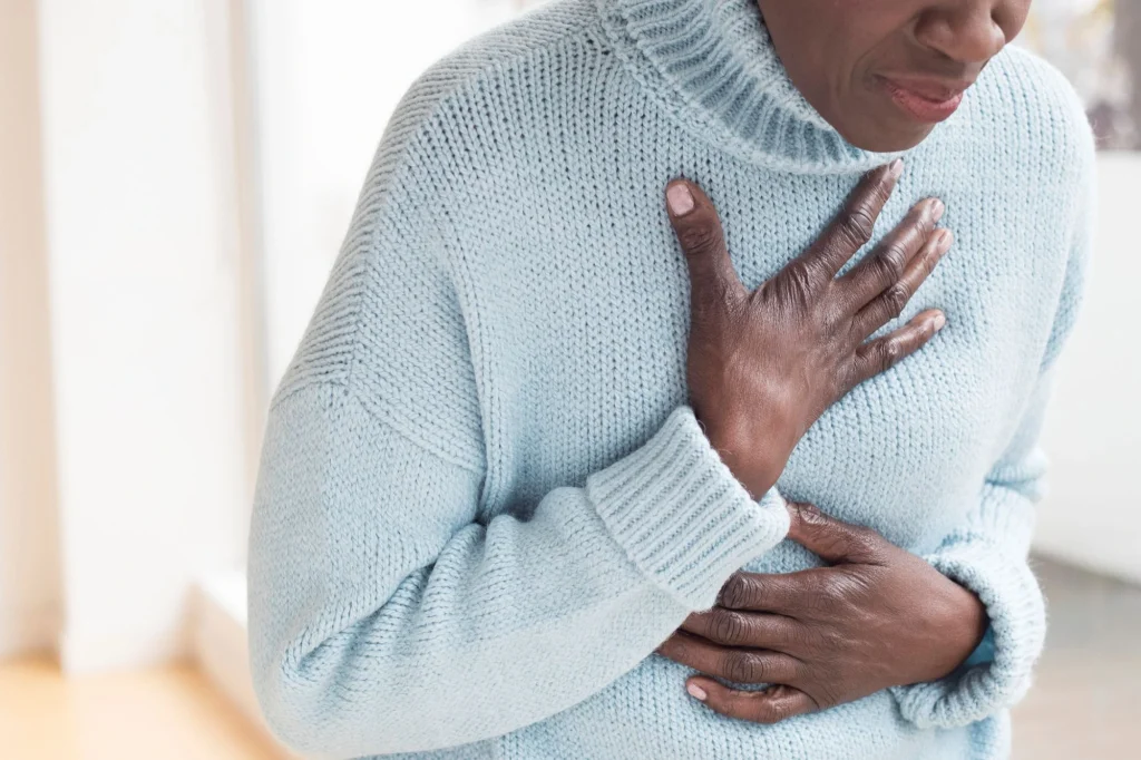 woman clutching chest heart attack