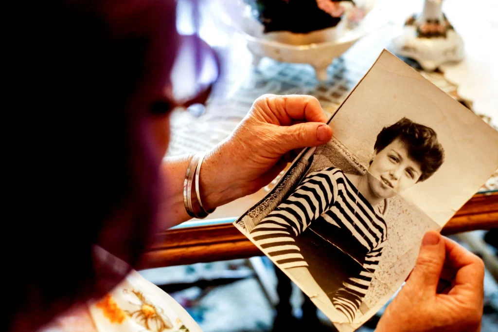 lady looking at photo of younger self