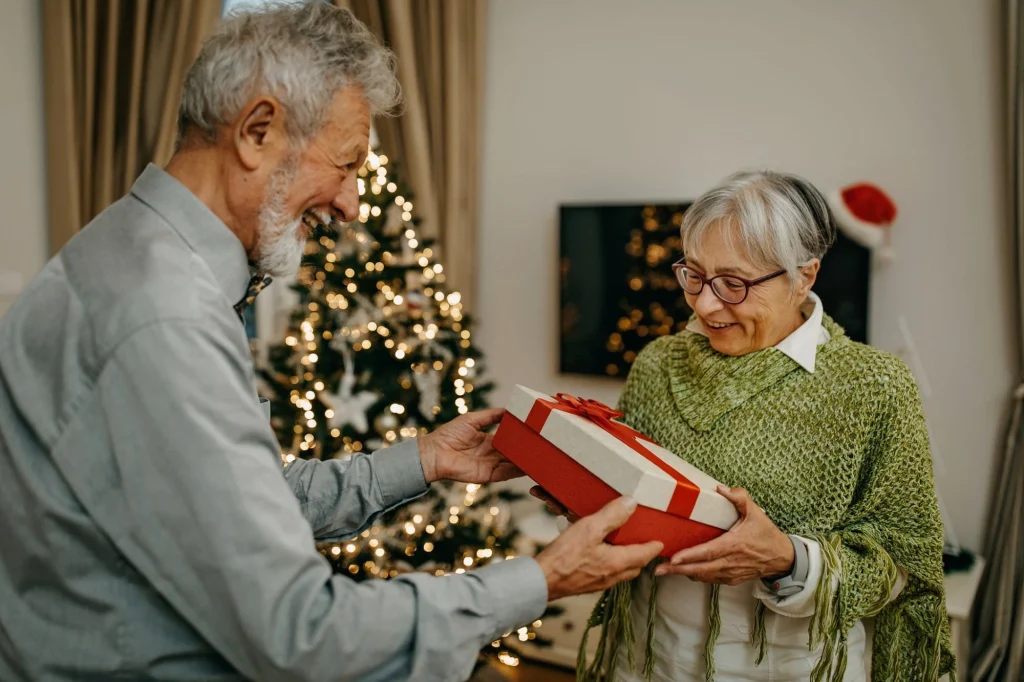 man handing present to woman