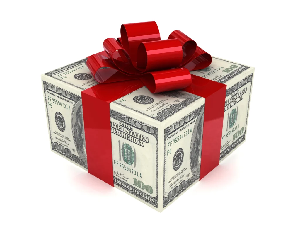 dollar bills in the shape of a box with a red ribbon to look like a gift