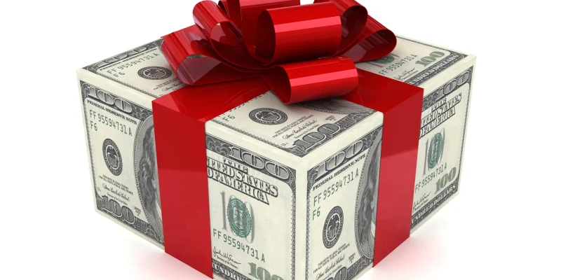 dollar bills in the shape of a box with a red ribbon to look like a gift