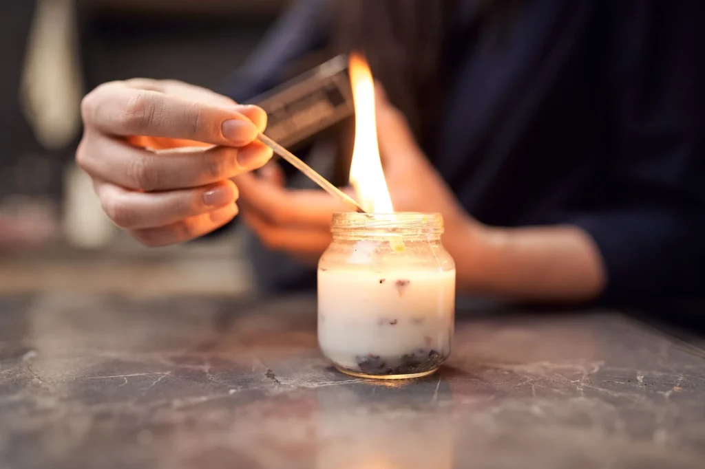 old lady lighting candle