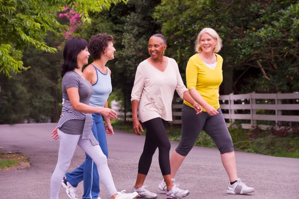 older friends walking together outside