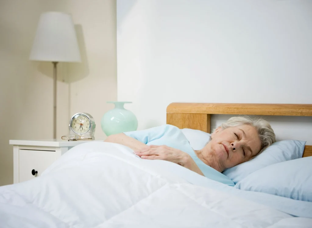 older lady asleep in her bed
