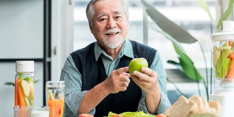 older asain man eating healthy food