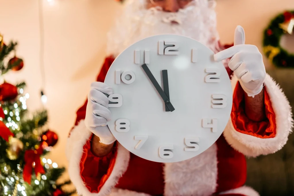 santa pointing to a clock
