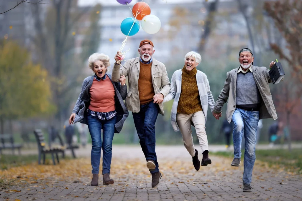 group of older adults playing outside with balloons