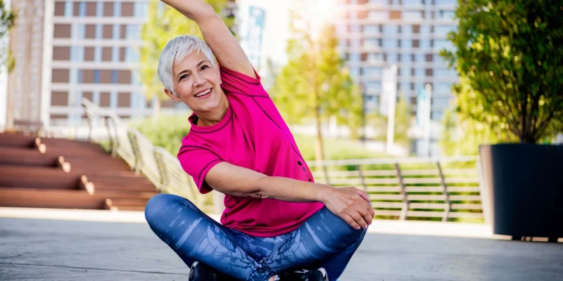 senior woman stretching outside
