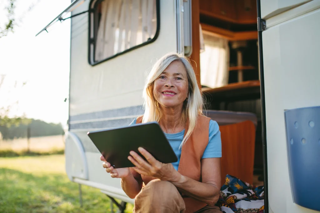retiree woman using a tablet and internet on RV