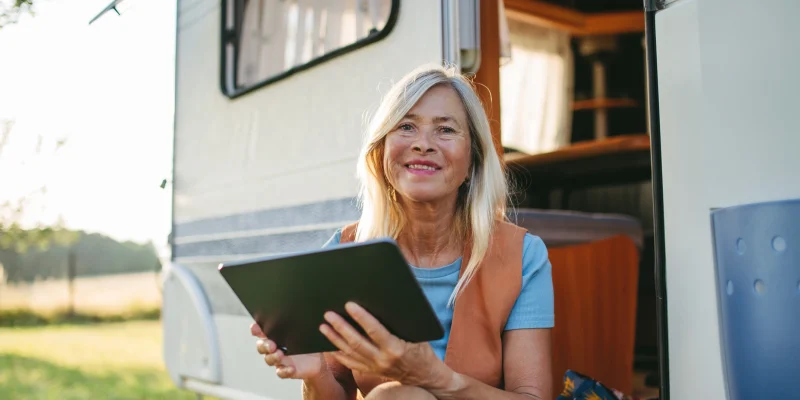 retiree woman using a tablet and internet on RV