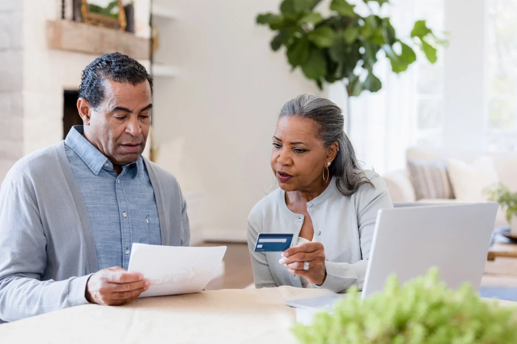 a man and his wife stressed over credit card statement