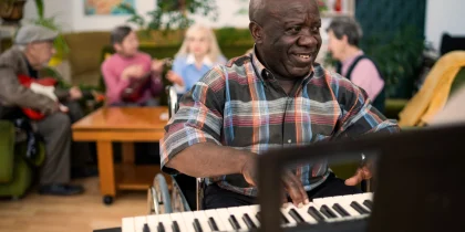african american senior man playing piano