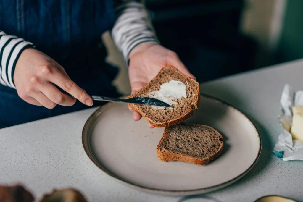 putting butter on toast