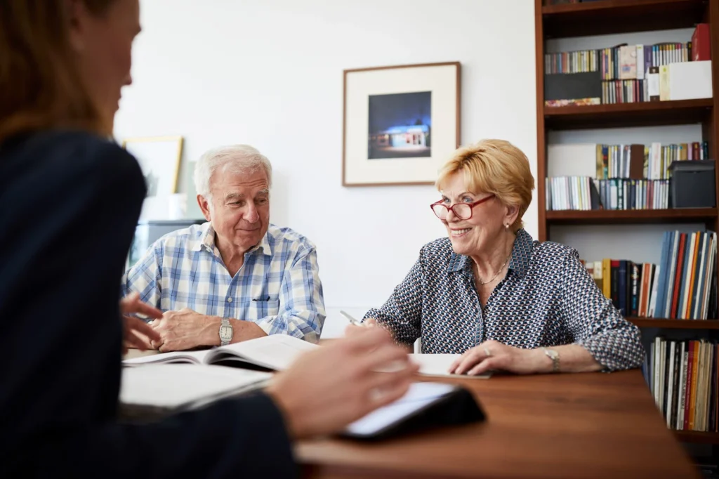 older couple working with professional woman meeting