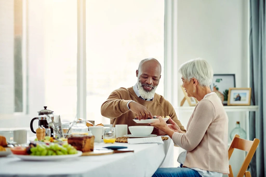 couple enjoying a meal at their table at home