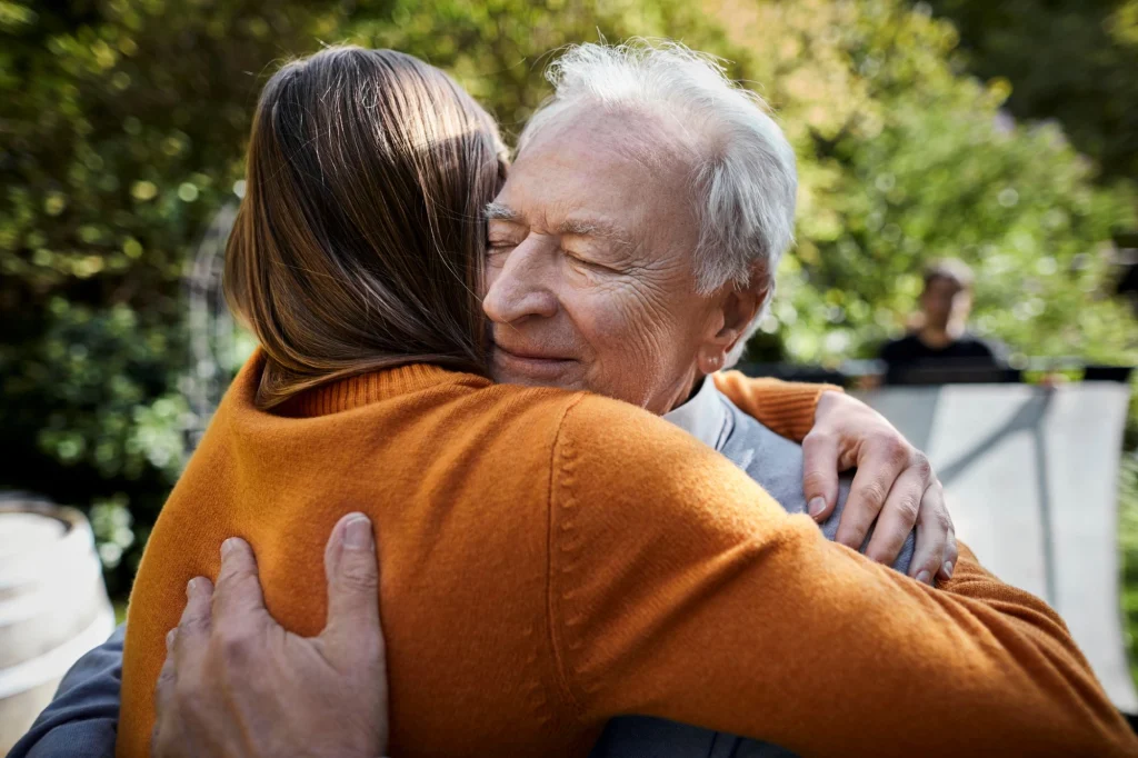 A daughter hugging her father in a sign of forgiveness.