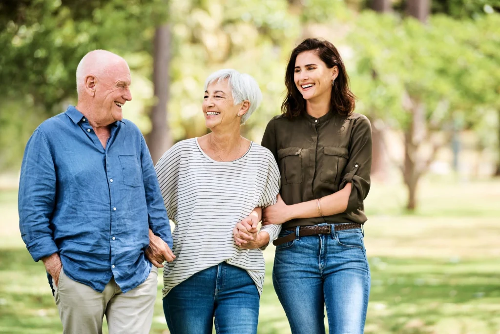 daughter with older parents walking